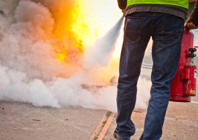 Decorative image of a man using a fire extinguisher